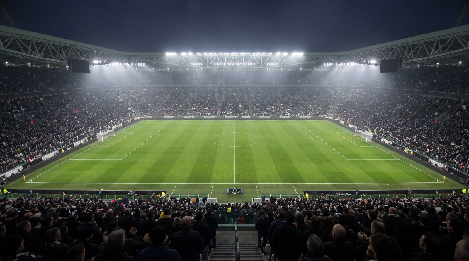 Estadio europeo de futbol lleno por la noche bajo los reflectores antes de un partido de selecciones